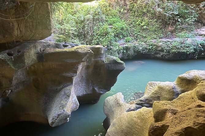 Charco Azul, Hidden Caves, Waterfalls, Beach, Free Adult Drinks - Charco Azul Canyon: blue water, rock ledges, and a wet start