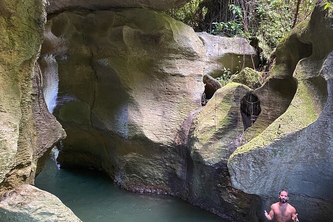 Rainforest Caves and Waterfalls Exploration with Transportation - Swimming through caves with a headlamp